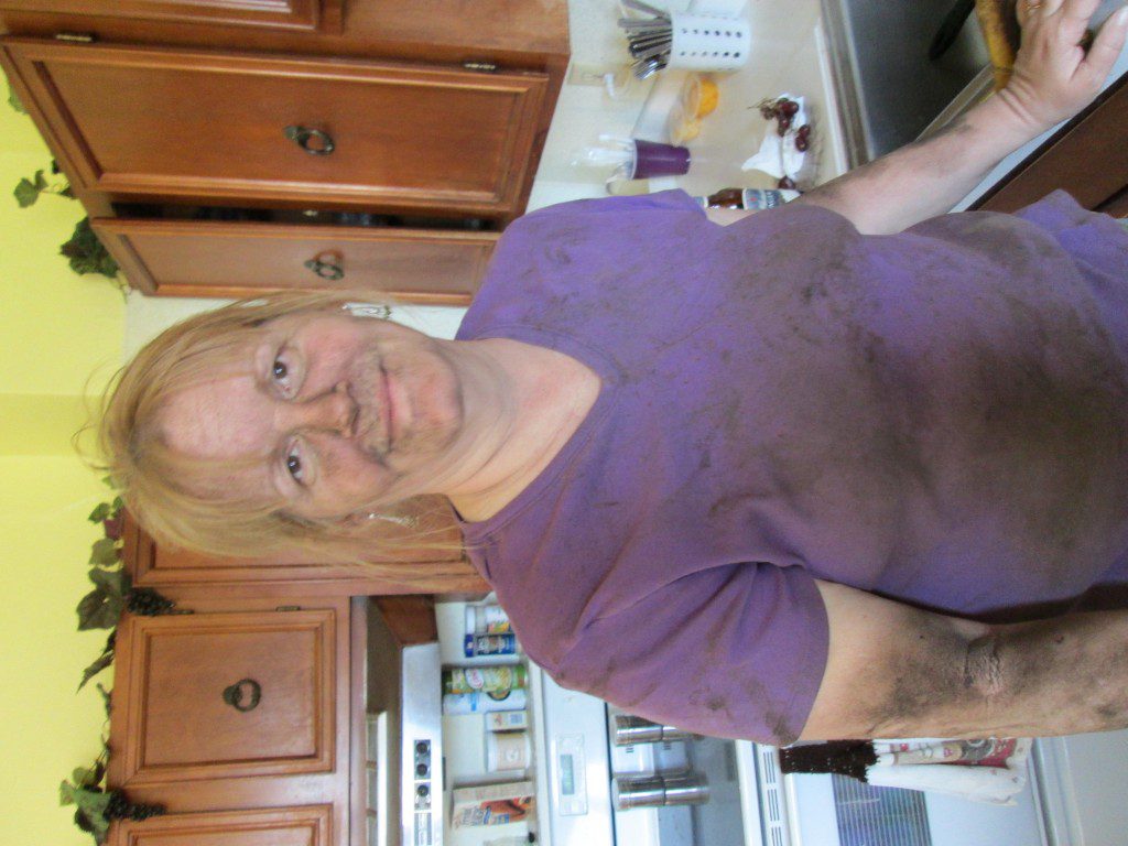 This is my mom about half-way through scraping all the crud off the bottom of said tractor... I think she looks great! Should have seen her at the end of it... haha. Though I gave her a hard time for not wearing a mask... 