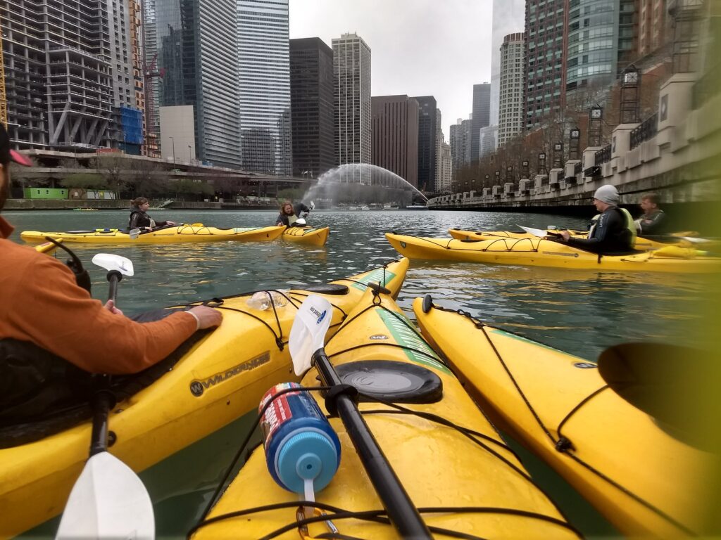 yellow sea kayaks on the Chicago river looking west over the building skyline downtown