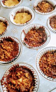 a muffin tin filled with homemade peanut butter cups