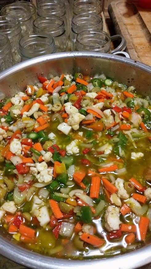 a pot of chopped brined and pickled vegetables for chicago style giardiniera about to be canned