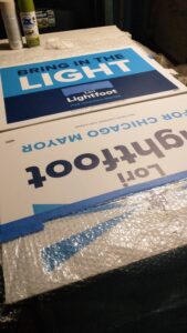 old Lori Lightfoot campaign signs from a previous chicago mayoral race are being recycled to enclose one side of this chicken coop brooder. The signs are masked off with plastic and painters tape and about to be spray-painted