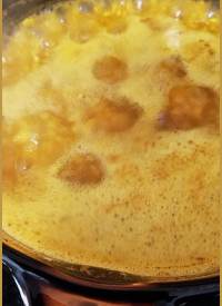 golden oats simmering in an amber glass corningware pot