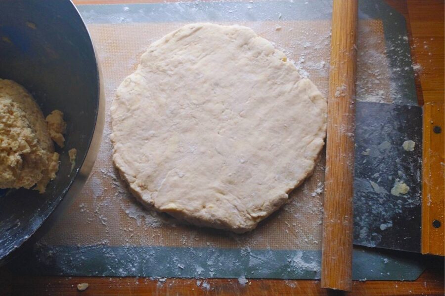 a circle of scone dough rolled out and ready to cut and bake.