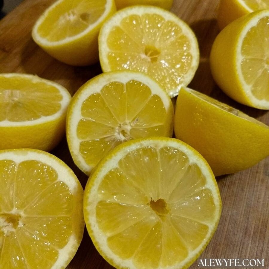 fresh lemon halves on a bamboo cutting board.