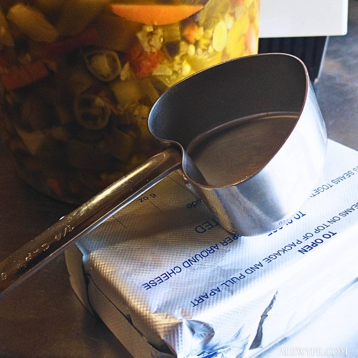 spicy pizza spread ingredients (cream cheese and giardiniera) and a heart-shaped measuring cup