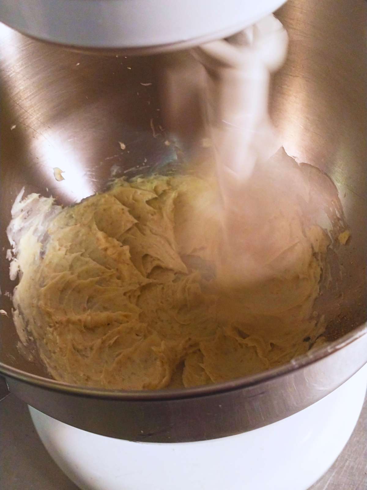 creaming butter in a white professional stand mixer with a shiny stainless bowl