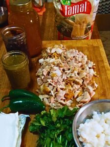 creamy chicken green chili tamale pie filling and masa ingredients mise en place on cutting board and in bowls