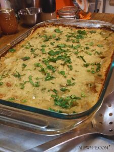 a pan of chicken tamale pie garnished with fresh cilantro and ready to serve