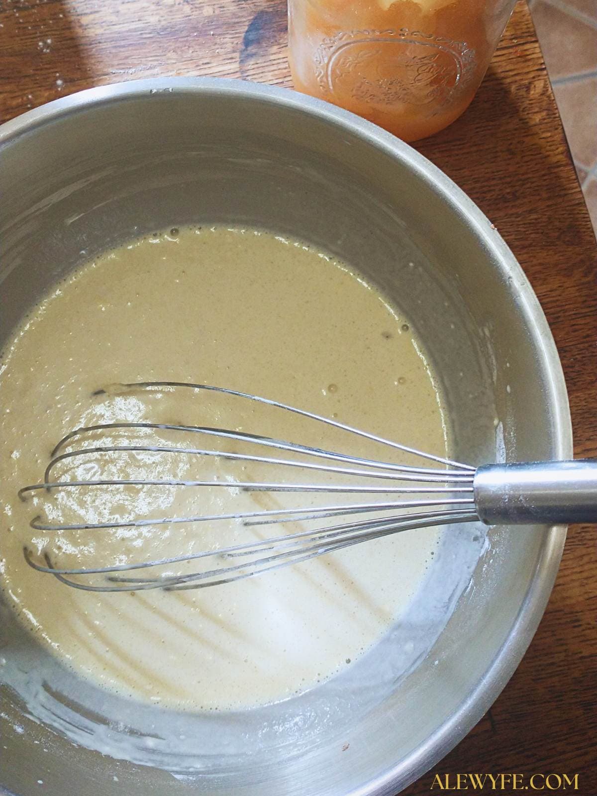 a bowl of batter with a whisk.