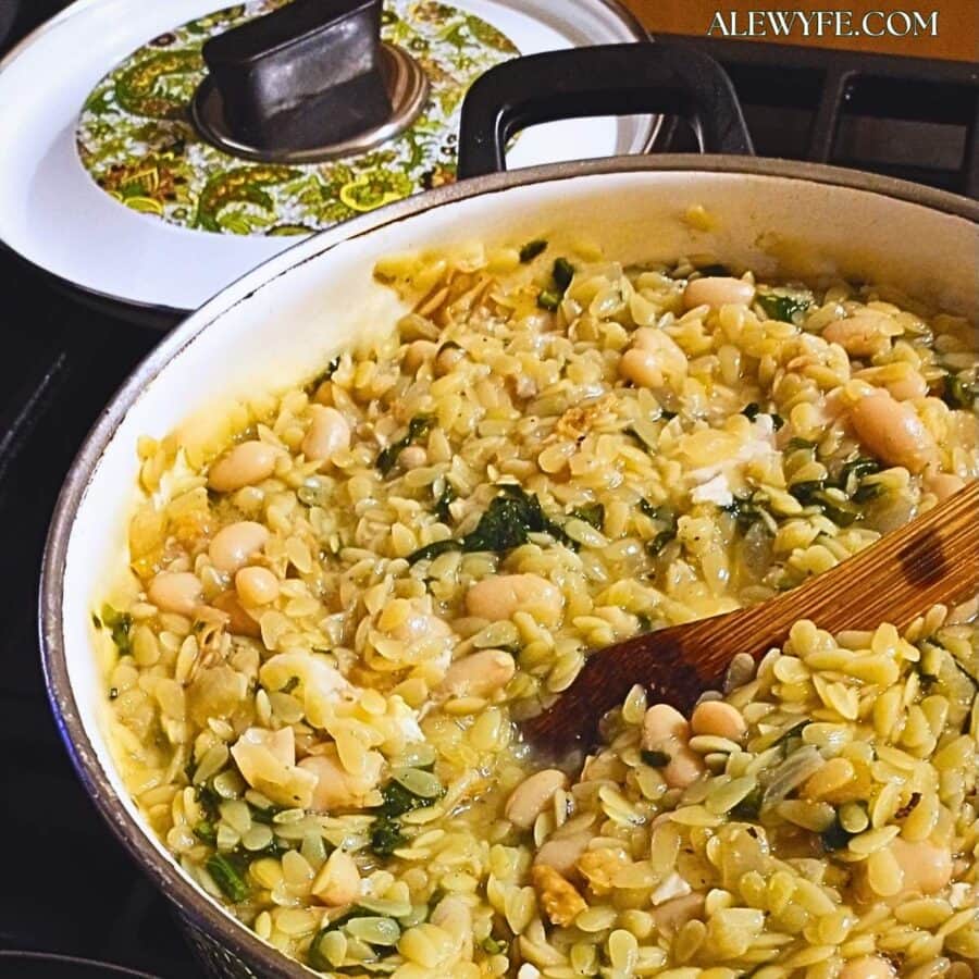 a pot of white bean orzo with radish greens, roasted chicken, and preserved lemon.