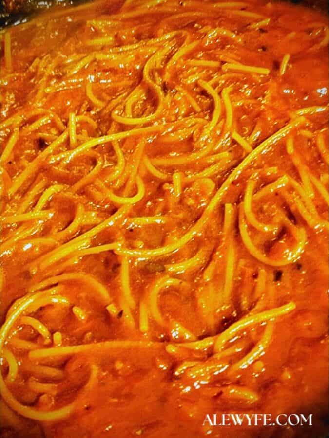 simmering spaghetti all'assassina in the chili tomato sauce. It still looks very soupy but will absorb the sauce as it cooks.