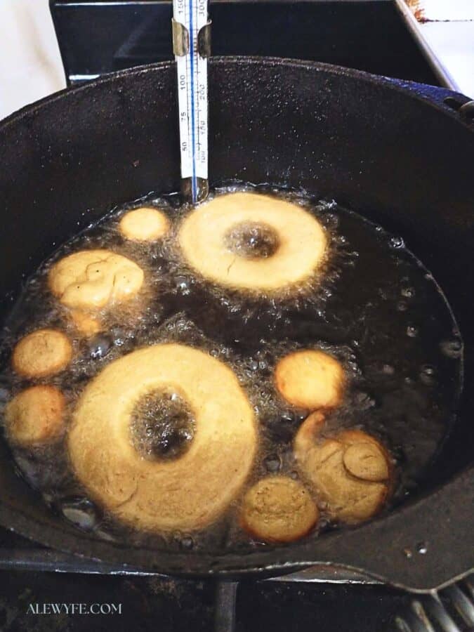 frying doughnuts in a cast iron dutch oven