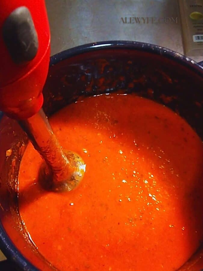 pureeing roasted red pepper sauce with an immersion blender