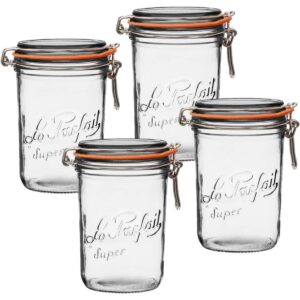 four glass le parfait jars with orange rubber seals and straight sides photographed against a white background.