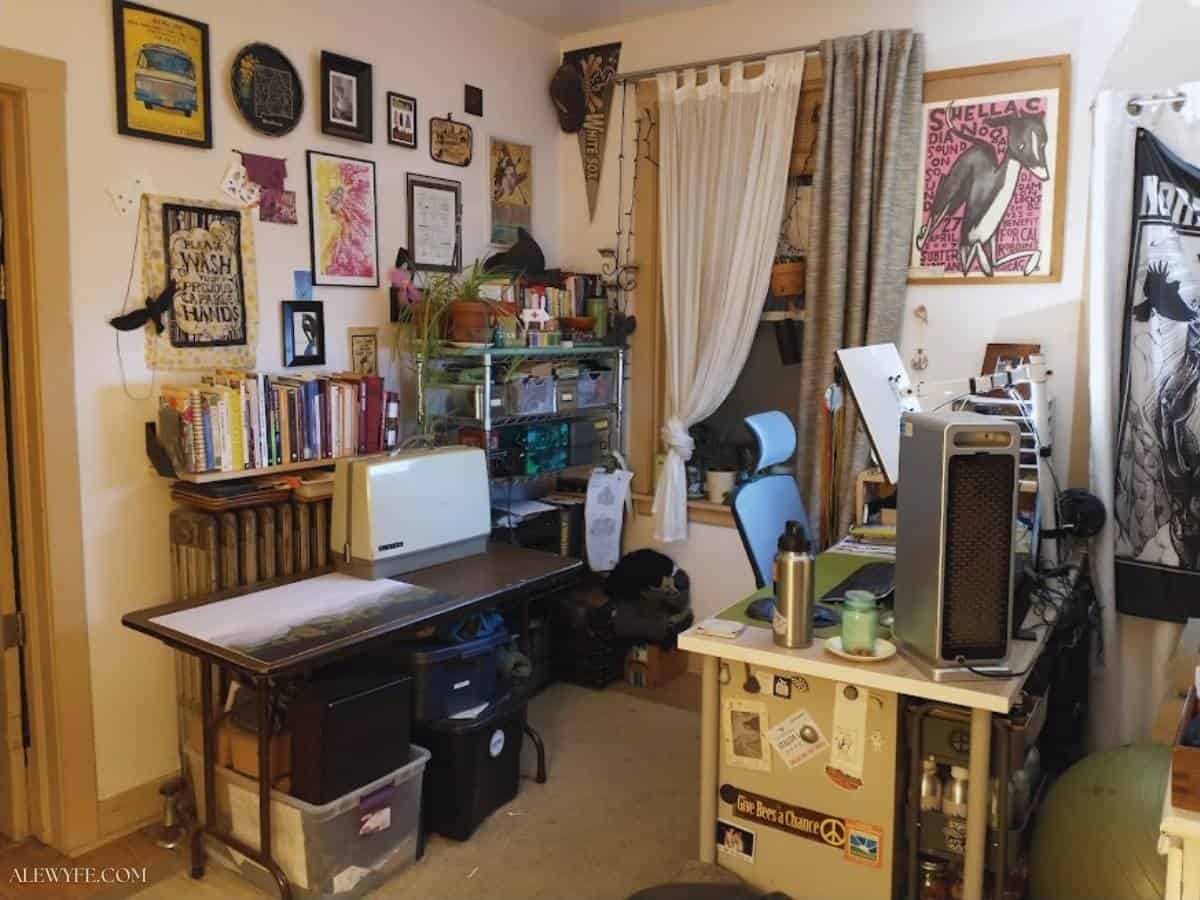 a photo of a crowded, cluttered office and craft workspace with colorful decor.