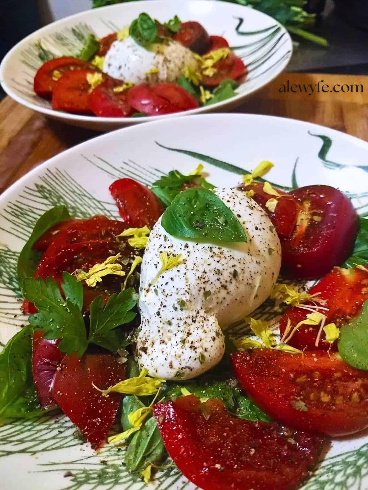 two bowls of heirloom tomato and burrata caprese salad.