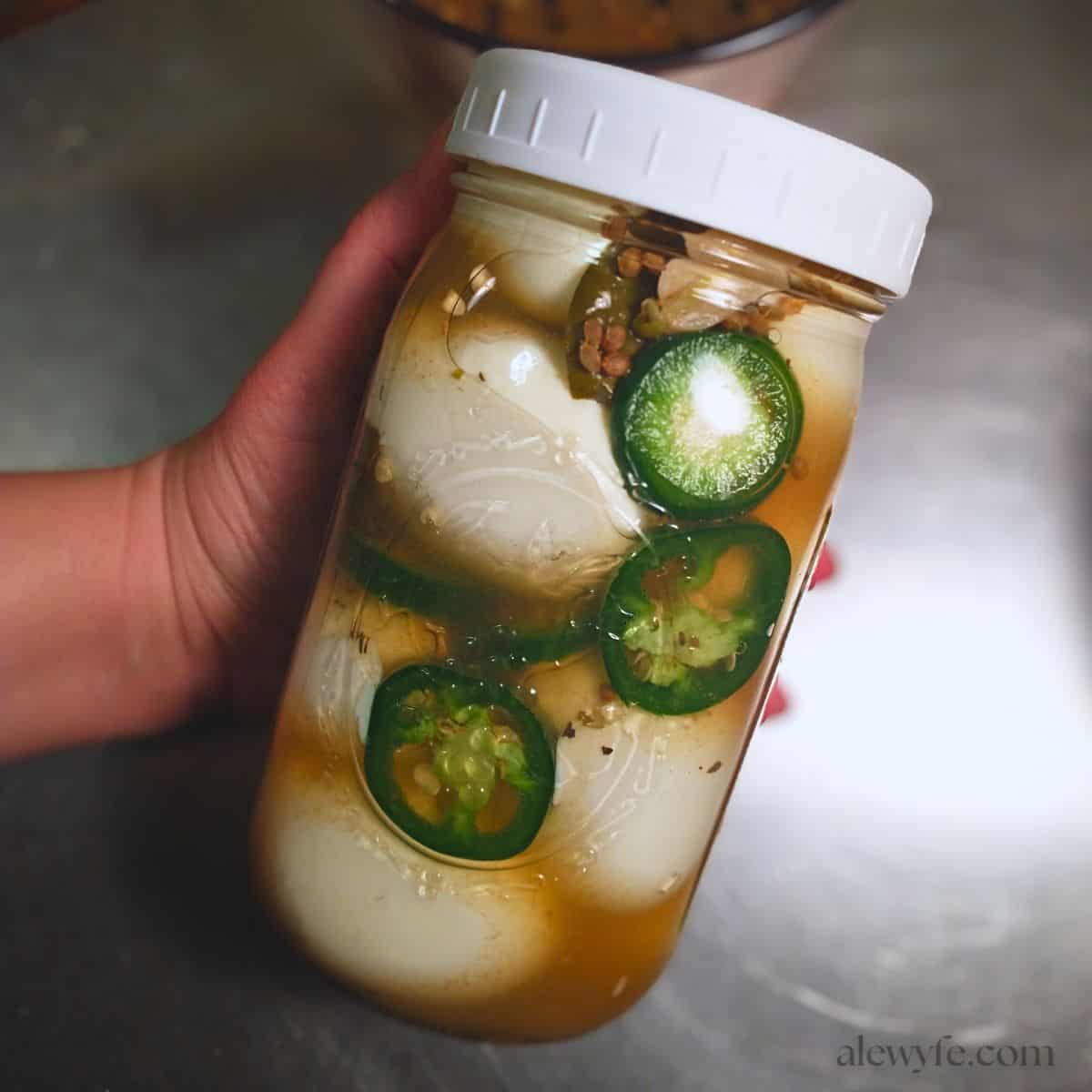a jar of jalapeno garlic pickled eggs.