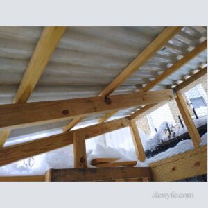 view of the underside of the finished chicken coop roof with a full snow load on the transparent panels.