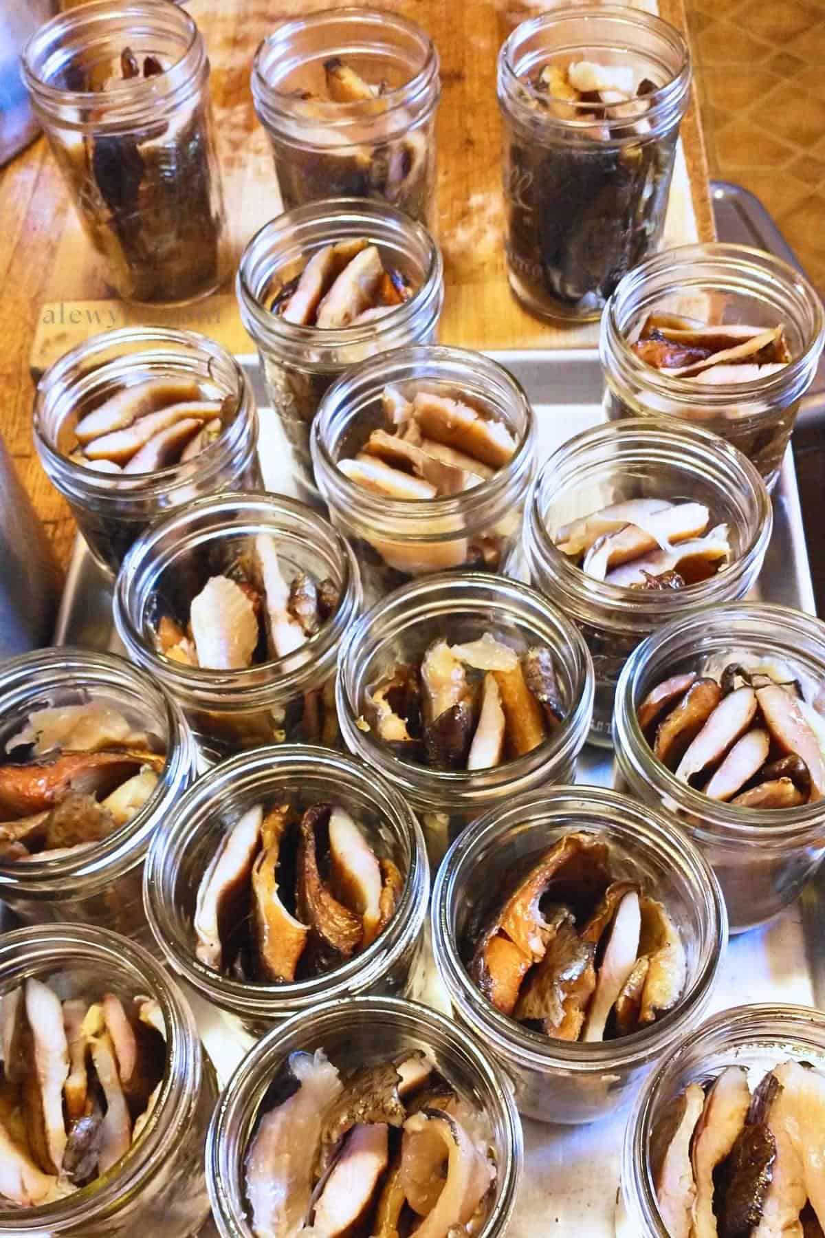 smoked trout packed and ready to pressure can in wide mouth pint mason jars.
