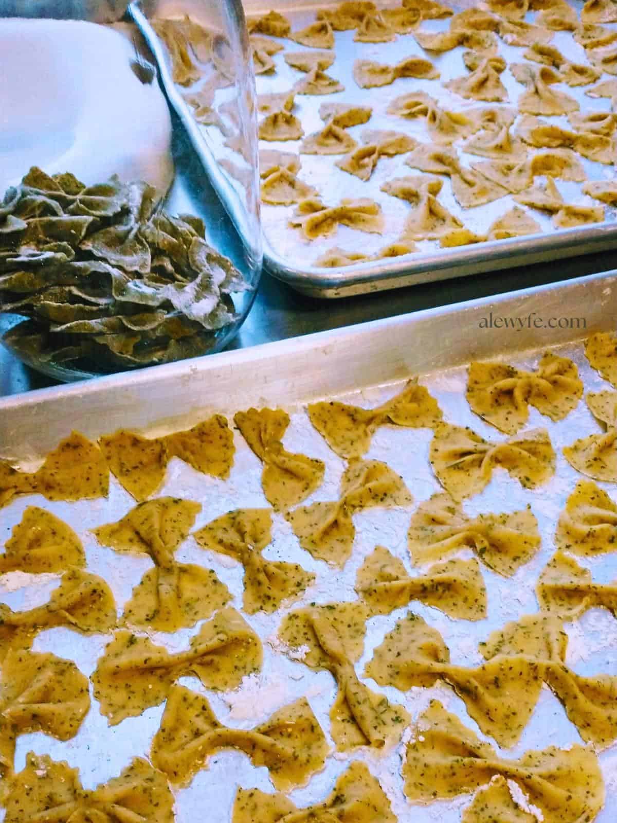 homemade farfalle bow tie pasta drying on sheets. 