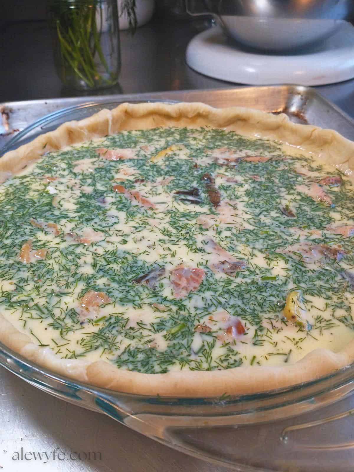 smoked trout quiche with egg custard before baking. 