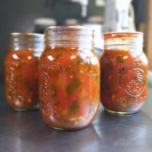 three canning jars of salsa ranchera.