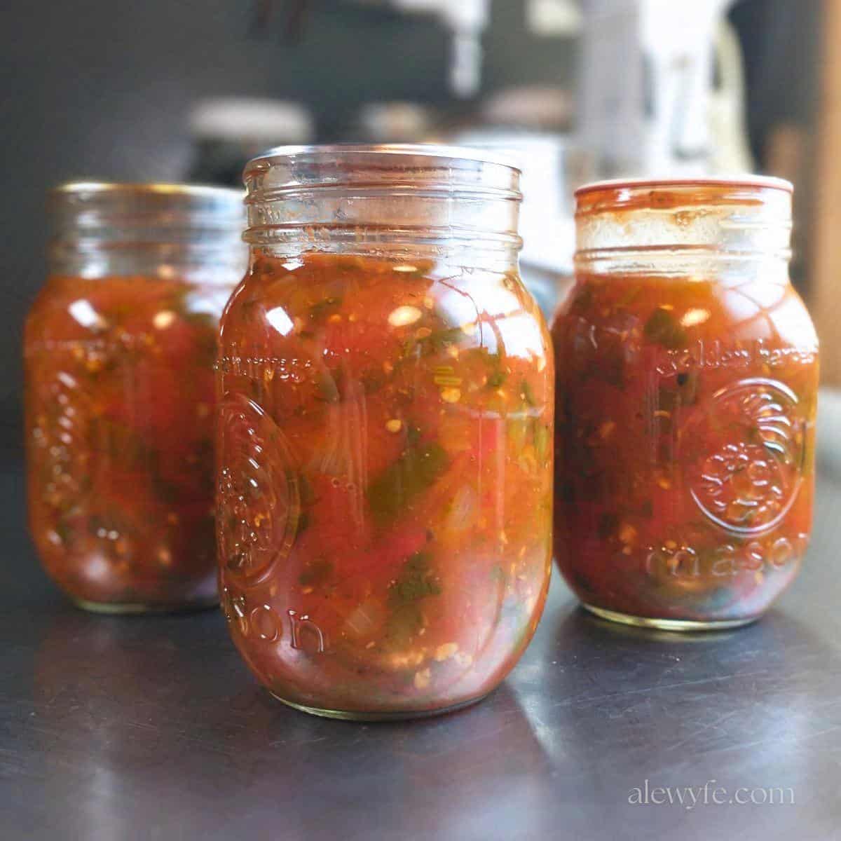 three canning jars of salsa ranchera.