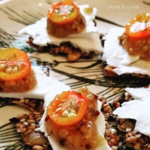 dried sungold tomato appetizers on homemade sesame flax crackers.