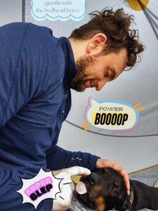 a man touches the nose of a dog, who is sticking out his tongue. comic text bubbles read, "goofin with the bedhead boyz", "super boop" and "power blep".