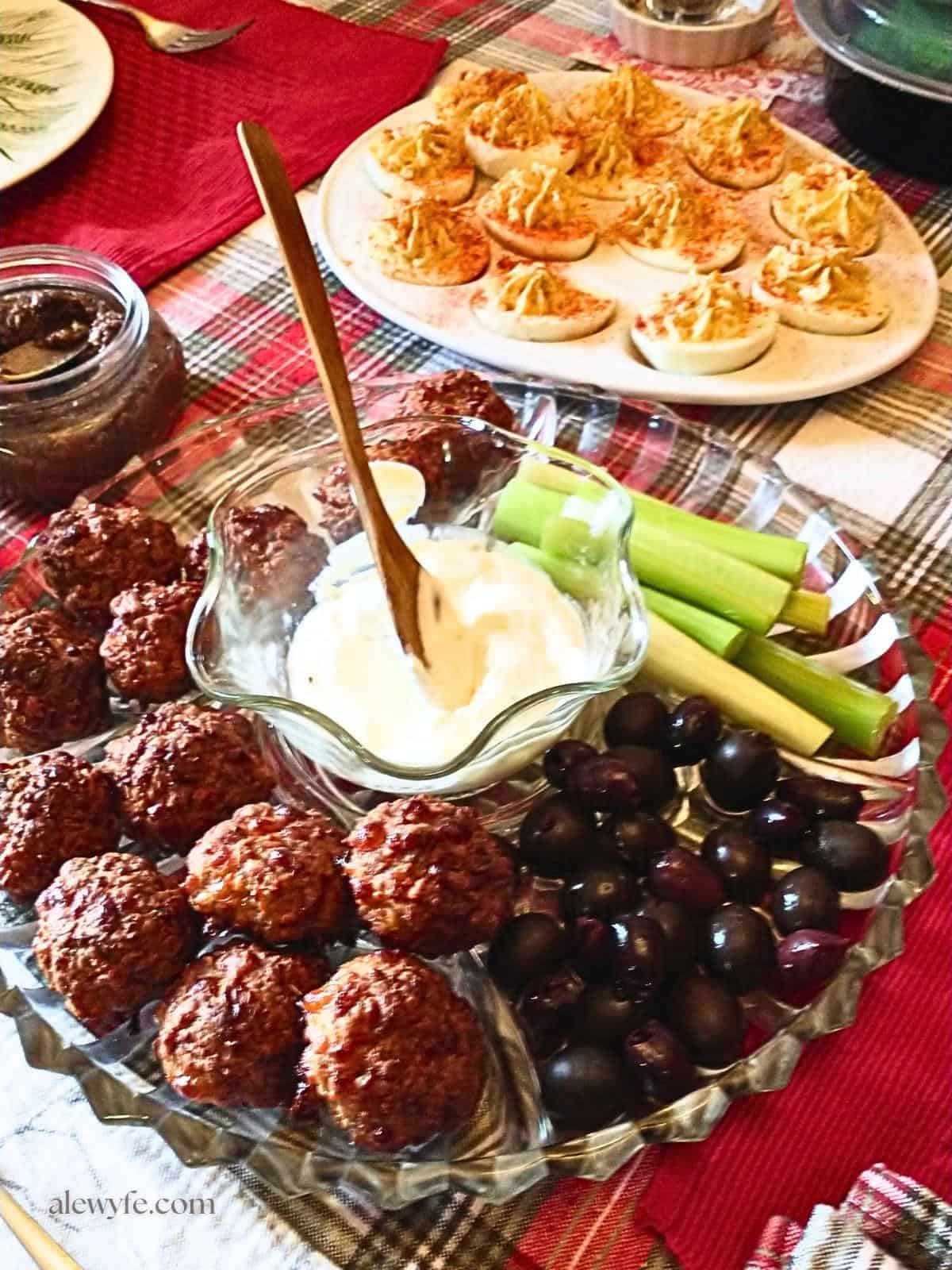 sausage balls, deviled eggs, and relish tray on a holiday table.