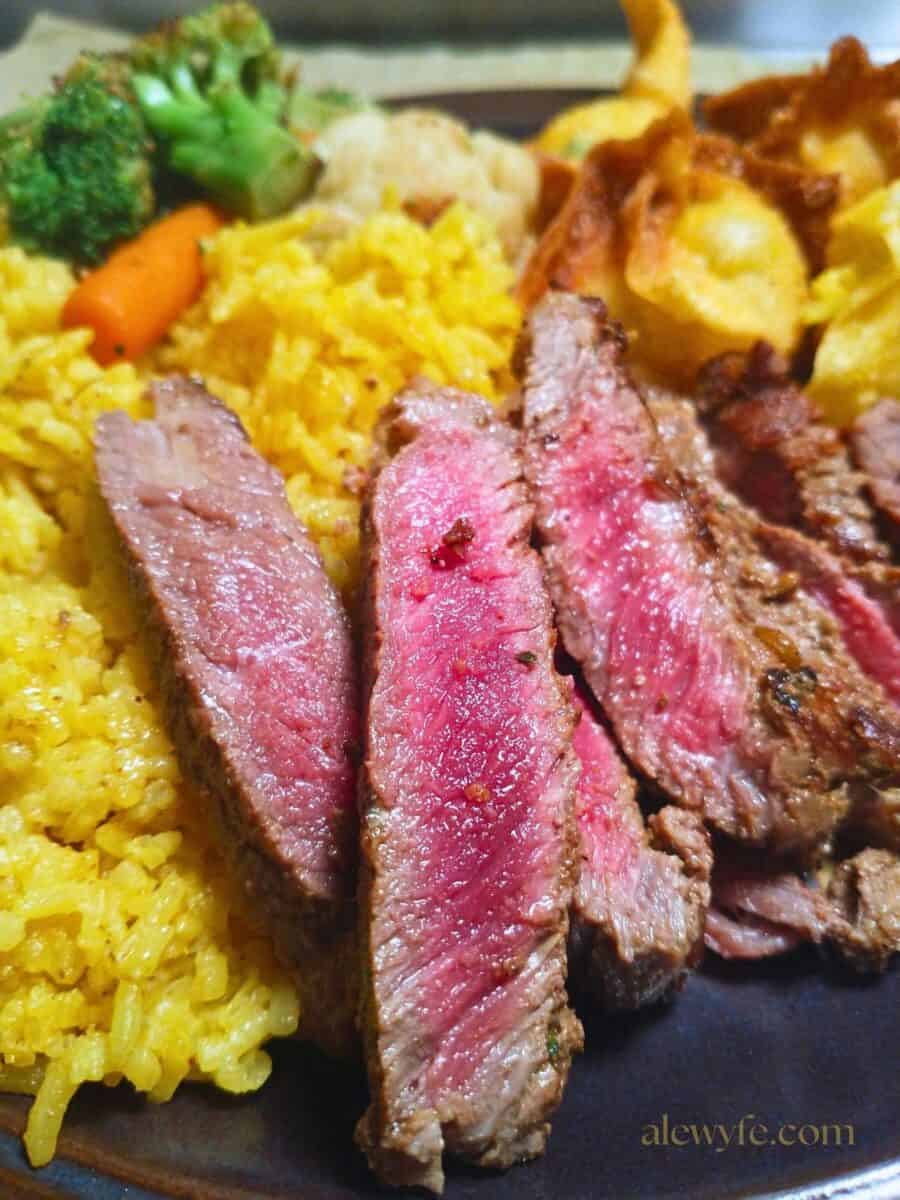 seared strips of venison backstrap steak over yellow rice with stir fried vegetables & fried wontons.