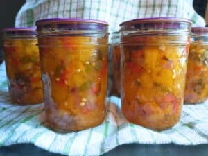 close-up side-view photo of habanero peach salsa jars.