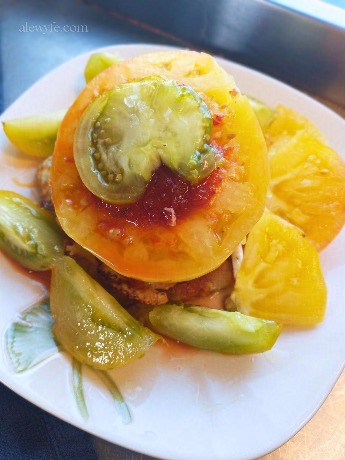 roasted tomato guajillo salsa with heirloom tomatoes, flaky salt, a fried egg, cheese, and a masa sope.