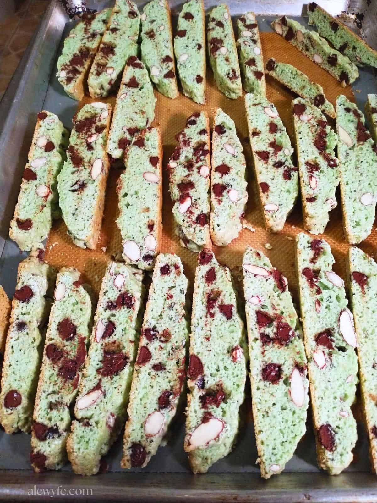 a cookie sheet with freshly baked mint chip biscotti cookies.