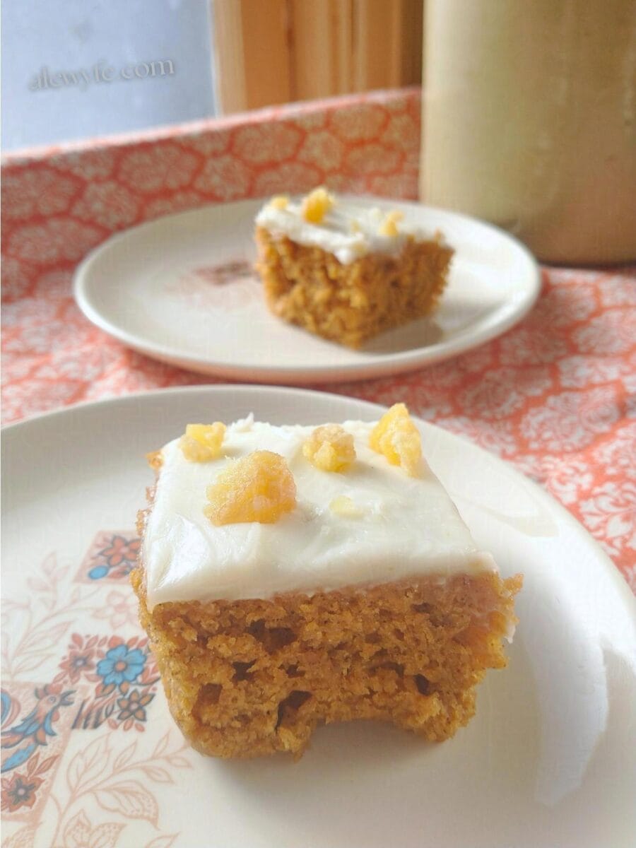 pumpkin bars with cream cheese icing and chunks of candied ginger on top.