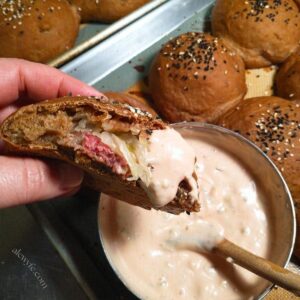 a reuben runza sandwich roll with thousand island dressing.