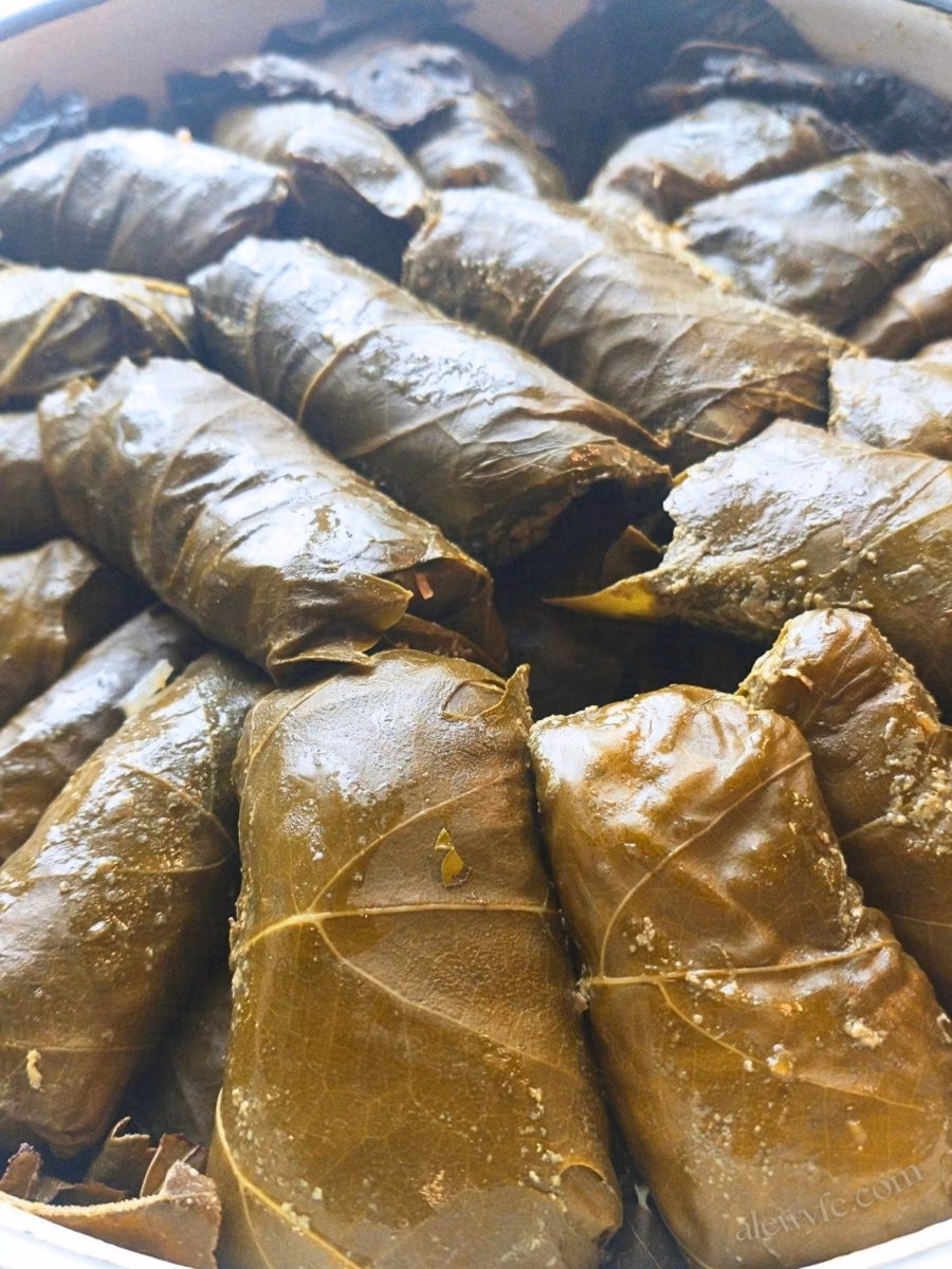 a pan of vegetarian dolmades stuffed with rice, currants, herbs, and nuts.