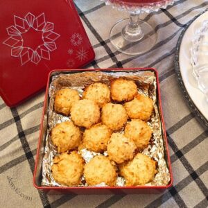 a foil-lined metal tin filled with baked coconut macaroons.