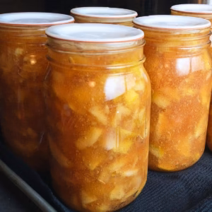 close-up photo of jars of homemade apple pie filling made with Clear Jel.