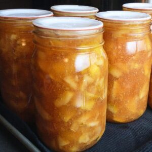 close-up photo of jars of homemade apple pie filling made with Clear Jel.